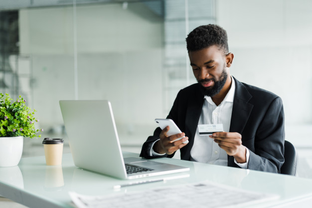 african-american-man-paying-with-credit-card-online-while-making-orders-via-mobile-internet-making-transaction-using-mobile-bank-application_231208-739