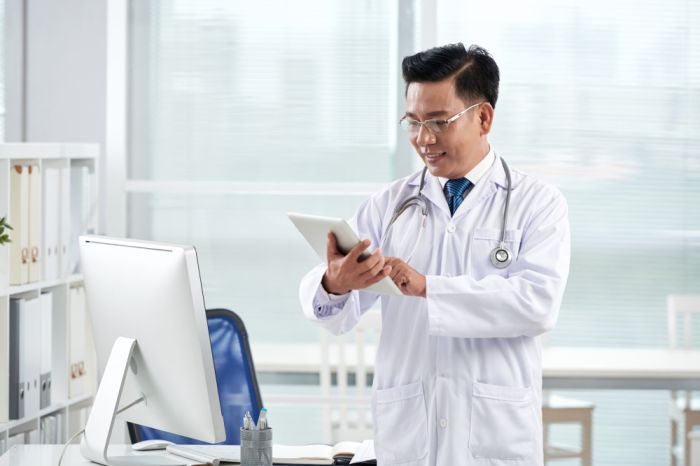 asian-doctor-using-medical-app-his-digital-device