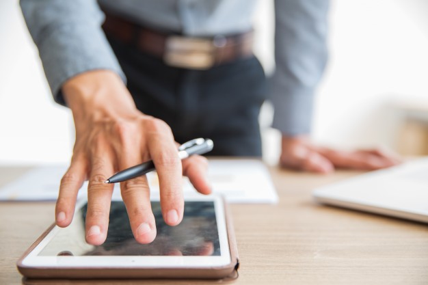 businessman-using-digital-tablet-office_1262-2239