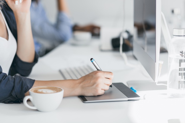 close-up-photo-female-hand-holding-stylus-tablet-indoor-portrait-freelance-web-developer-working-project-during-coffee-break-office_197531-3745