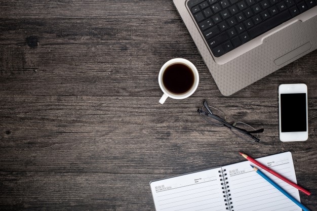 desk-with-laptop-cup-coffee-calendar_1112-145