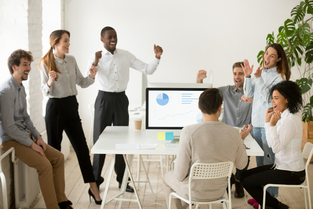 excited-by-good-news-motivated-colleagues-celebrating-corporate-success-together