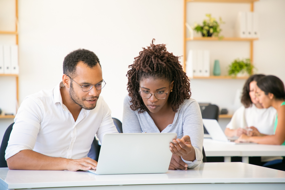 front-view-concentrated-employees-working-with-laptop