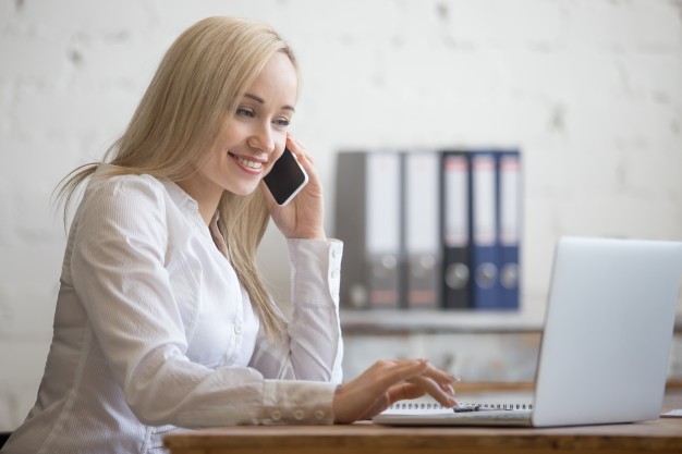 happy-businesswoman-working-her-office_1163-1607