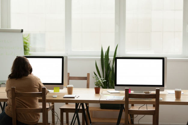 modern-office-coworking-space-with-woman-working-alone-computer_1163-4899