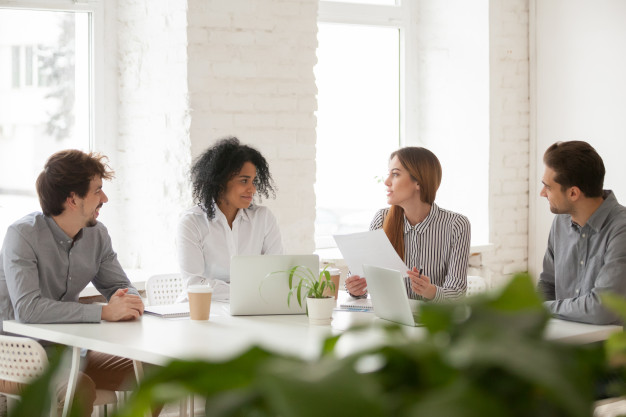 multiracial-male-female-colleagues-having-discussion-team-meeting_1163-5107