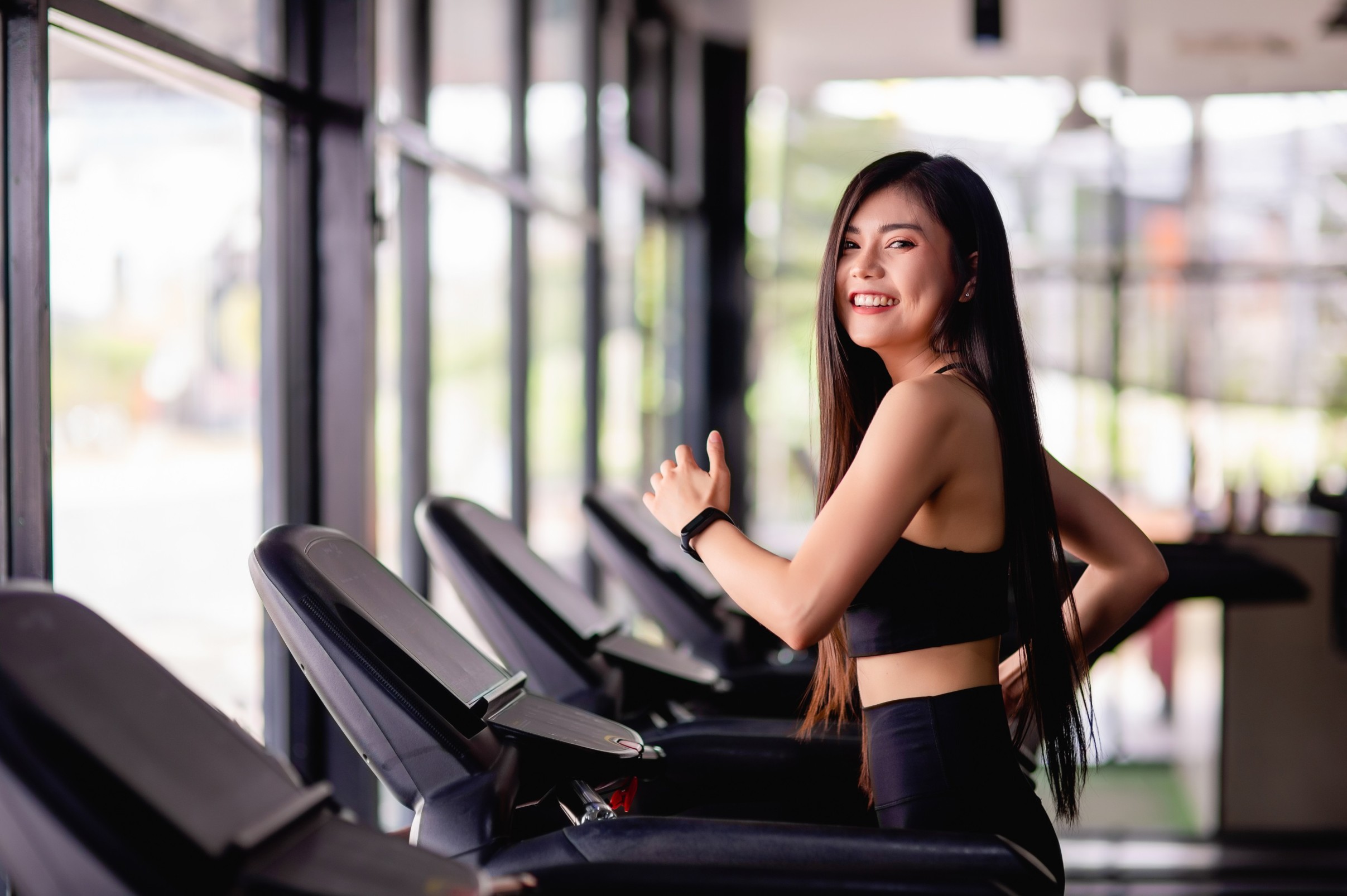 portrait-young-healthy-woman-running-treadmill-she-smile-during-workout-gym-healthy-lifestyle-concept-copy-space-vertical-image (1) (1)