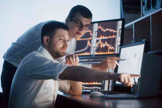 team-stockbrokers-are-having-conversation-dark-office-with-display-screens-analyzing-data-graphs-reports-investment-purposes-creative-teamwork-traders_146671-15017 (1)