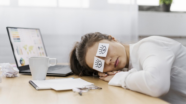 tired-businesswoman-covering-her-eyes-with-drawn-eyes-paper_23-2148813192