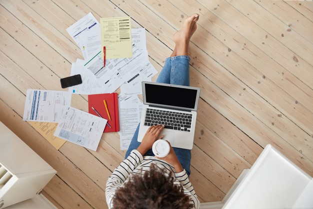 view-from-unrecognizable-afro-woman-reads-information-from-paper-documents_273609-18026