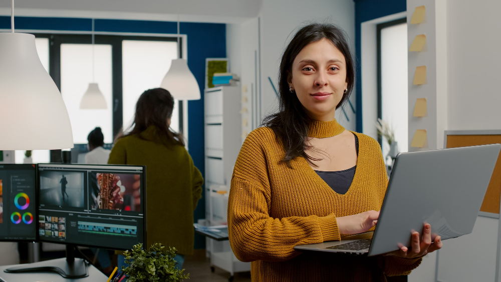woman-retoucher-looking-camera-smiling-working-creative-media-agency-standing-front-webc